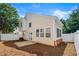Two-story home exterior showing back of the house with a sliding glass door and white fencing at 486 Windcroft Nw Cir, Acworth, GA 30101