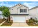 Charming two-story home features a well-maintained lawn, two car garage, and traditional vinyl siding at 486 Windcroft Nw Cir, Acworth, GA 30101
