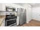 The modern kitchen features stainless steel appliances, granite counters, and new cabinets at 486 Windcroft Nw Cir, Acworth, GA 30101