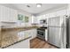 The modern kitchen features stainless steel appliances, granite counters, and new cabinets at 486 Windcroft Nw Cir, Acworth, GA 30101