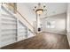 Spacious living room with fireplace, built-in shelving, hardwood floors, and a stylish chandelier at 486 Windcroft Nw Cir, Acworth, GA 30101