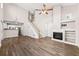 Open-concept living room boasts a fireplace, hardwood floors, open staircase, and modern kitchen view at 486 Windcroft Nw Cir, Acworth, GA 30101
