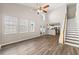 Bright living room with high ceilings, modern ceiling fan, lots of windows, and hardwood floors at 486 Windcroft Nw Cir, Acworth, GA 30101