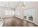 Bright living room with high ceilings, modern ceiling fan, hardwood floors, and access to the back patio at 486 Windcroft Nw Cir, Acworth, GA 30101