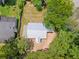 A bird's eye view of the property showcasing the roof and surrounding trees at 5233 Groovers Landing Se Rd, Acworth, GA 30101