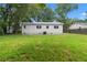 A spacious backyard features a grassy lawn and the exterior of the house at 5233 Groovers Landing Se Rd, Acworth, GA 30101