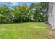 A well-maintained, grassy backyard surrounded by mature trees at 5233 Groovers Landing Se Rd, Acworth, GA 30101
