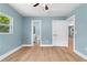 Cozy bedroom with hardwood floors, a ceiling fan, and access to a bathroom at 5233 Groovers Landing Se Rd, Acworth, GA 30101