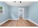 An airy bedroom features blue walls, hardwood floors, and bright natural light at 5233 Groovers Landing Se Rd, Acworth, GA 30101