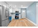 Updated kitchen with stainless steel appliances, white cabinets, and bright, modern lighting at 5233 Groovers Landing Se Rd, Acworth, GA 30101