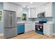 Modern kitchen with stainless steel appliances and sleek white cabinetry and countertops at 5233 Groovers Landing Se Rd, Acworth, GA 30101
