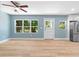 Open living space with wood floors, abundant natural light and stainless steel appliances at 5233 Groovers Landing Se Rd, Acworth, GA 30101