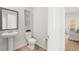 Neat half bathroom with a pedestal sink and a door leading to dining area at 105 Crooked Lake Park, Villa Rica, GA 30180