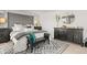 Beautiful bedroom featuring a gray upholstered headboard, patterned rug, and stylish decor for a relaxing atmosphere at 105 Crooked Lake Park, Villa Rica, GA 30180