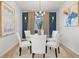Elegant dining room featuring a glass table, white chairs, and sophisticated decor at 105 Crooked Lake Park, Villa Rica, GA 30180