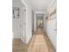 Bright hallway featuring light hardwood flooring and neutral colored walls with decorative art at 105 Crooked Lake Park, Villa Rica, GA 30180