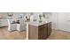 Bright eat-in kitchen featuring an island with granite countertops and modern finishes at 105 Crooked Lake Park, Villa Rica, GA 30180