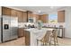 Spacious kitchen featuring stainless steel appliances, a central island, and wooden cabinetry at 105 Crooked Lake Park, Villa Rica, GA 30180