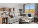 Comfortable living room with plush sofa, large windows, and a view into the open kitchen area at 105 Crooked Lake Park, Villa Rica, GA 30180