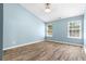 Spacious bedroom with hardwood floors and two windows at 110 Holly Mill Village Dr, Canton, GA 30114