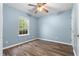 Inviting bedroom with wood floors, natural light, and ceiling fan at 110 Holly Mill Village Dr, Canton, GA 30114