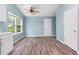 Bright dining area with hardwood floors, ceiling fan, and natural light from a large window at 110 Holly Mill Village Dr, Canton, GA 30114