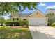 Charming single-story home with a well-maintained lawn, mature trees, and a two-car garage at 110 Holly Mill Village Dr, Canton, GA 30114