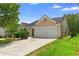 Inviting home exterior with a two-car garage, tidy landscaping, and a paved driveway at 110 Holly Mill Village Dr, Canton, GA 30114