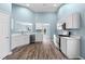 Bright kitchen with white cabinets, stainless steel appliances, and an open view to the living area at 110 Holly Mill Village Dr, Canton, GA 30114