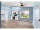 Open floor plan with kitchen, dining area, stainless appliances, and hardwood floors at 110 Holly Mill Village Dr, Canton, GA 30114