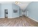 Spacious living room featuring hardwood floors and a glimpse into the open-concept kitchen at 110 Holly Mill Village Dr, Canton, GA 30114