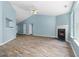 Open living area with a vaulted ceiling, modern fireplace, wood floors, and large windows at 110 Holly Mill Village Dr, Canton, GA 30114