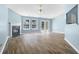 Bright living room featuring a fireplace, hardwood floors, and double doors to the outside at 110 Holly Mill Village Dr, Canton, GA 30114