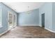 Cozy space with hardwood floors, modern chandelier, and access to the outdoor space through double doors at 110 Holly Mill Village Dr, Canton, GA 30114