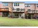 Townhome backyard features multiple decks and patios overlooking a green lawn at 2227 Foley Park St, Snellville, GA 30078