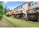 Exterior view of brick townhomes with wooden decks and a well-maintained grassy backyard at 2227 Foley Park St, Snellville, GA 30078