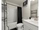 Compact bathroom features a shower and tub combo, toilet, vanity, and storage at 2227 Foley Park St, Snellville, GA 30078