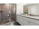 Modern bathroom with a tiled shower, granite countertops, and a dual sink vanity at 2227 Foley Park St, Snellville, GA 30078