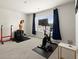 Bright bedroom with a window featuring a workout station with weights and a bike at 2227 Foley Park St, Snellville, GA 30078
