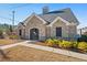 Exterior of the clubhouse featuring brick and stone facade, set amidst a landscaped lawn at 2227 Foley Park St, Snellville, GA 30078