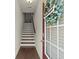 Inviting foyer features a staircase, hardwood floors, and a decorative wreath on the front door at 2227 Foley Park St, Snellville, GA 30078