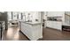 Well-equipped kitchen featuring an island with sink and stainless steel appliances, with a view to the dining area at 2227 Foley Park St, Snellville, GA 30078