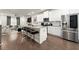Open-concept kitchen featuring stainless steel appliances, granite countertops, and an island with barstool seating at 2227 Foley Park St, Snellville, GA 30078