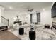 Stylish living room with hardwood floors, modern furnishings, fireplace, and a ceiling fan at 2227 Foley Park St, Snellville, GA 30078