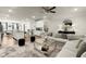 Bright, open-concept living room featuring modern décor, a stylish rug, and seamlessly connected to the kitchen at 2227 Foley Park St, Snellville, GA 30078
