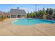 Community pool with plenty of open deck space and a covered lounging area at 2227 Foley Park St, Snellville, GA 30078