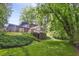 Backyard showcasing green grass, mature trees, a sunroom, and a wooden fence at 3282 Leslie Court Northeast Ne Ct, Atlanta, GA 30345