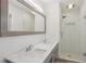 Bathroom featuring double sinks with marble countertop and glass-enclosed shower at 3282 Leslie Court Northeast Ne Ct, Atlanta, GA 30345