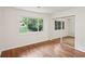 Bright bedroom featuring hardwood floors, sliding closet doors, and a window view at 3282 Leslie Court Northeast Ne Ct, Atlanta, GA 30345