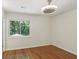 Bright bedroom with hardwood floors, large window, and modern ceiling fan at 3282 Leslie Court Northeast Ne Ct, Atlanta, GA 30345